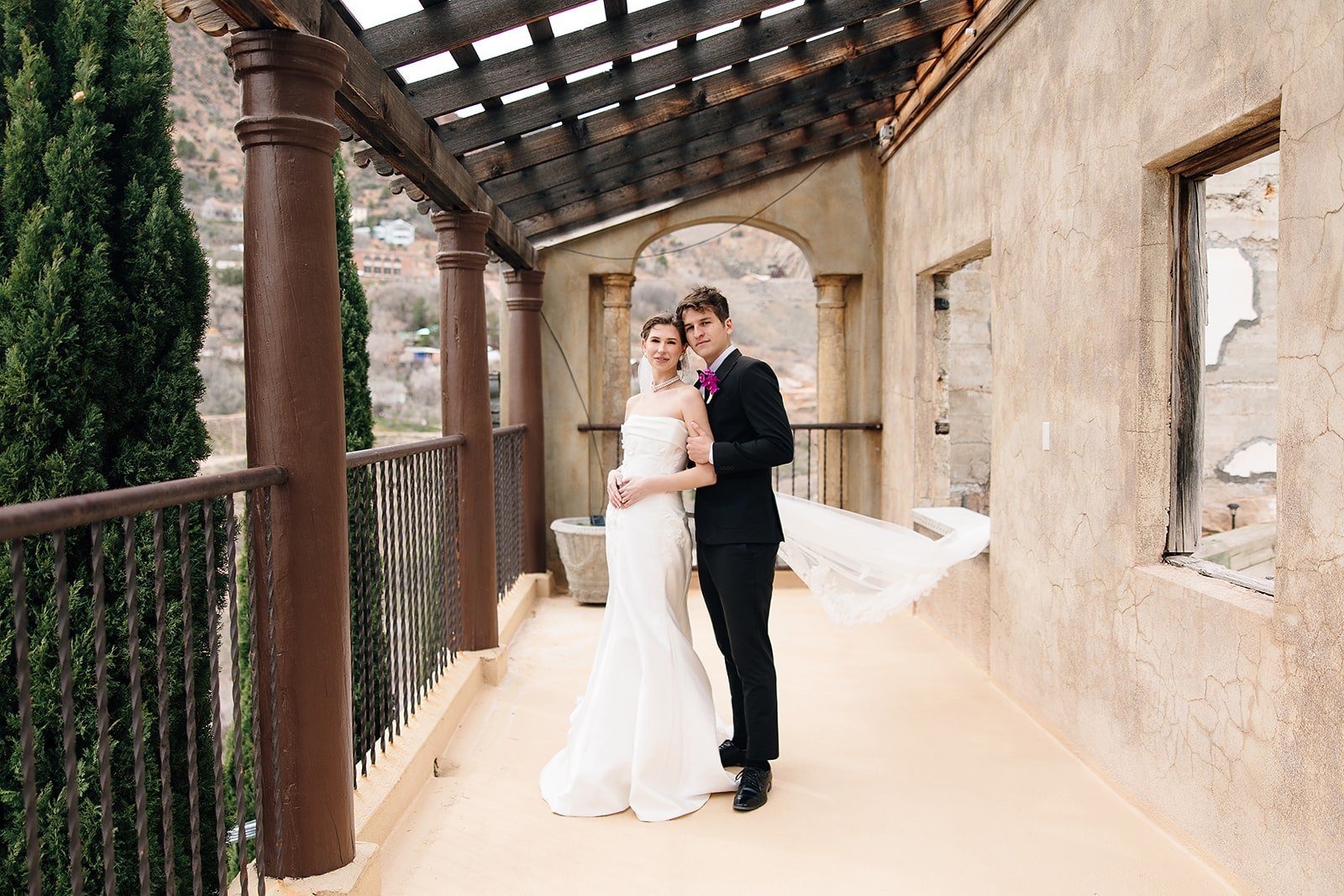 Aerial view of a hillside wedding venue overlooking a mountain town
