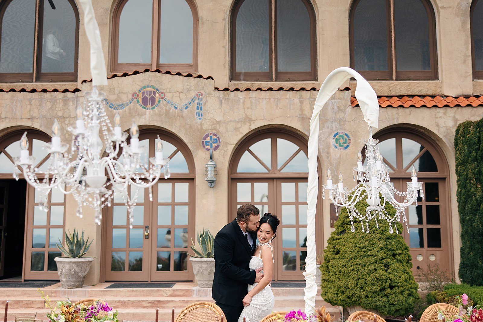 Overhead view of an outdoor wedding reception tablescape with florals